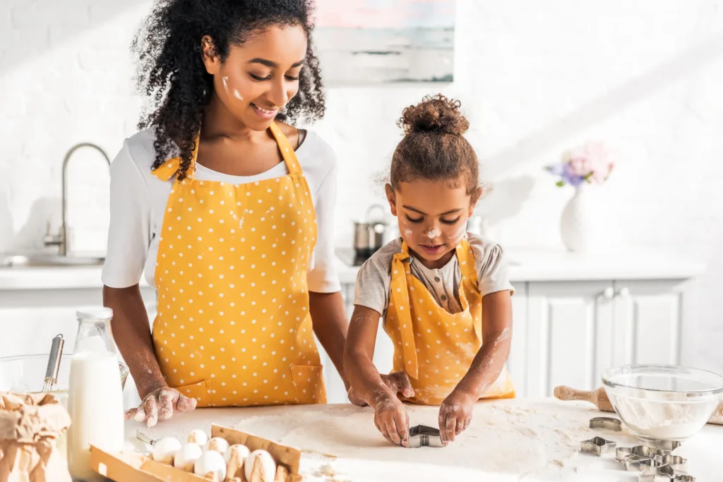 Mom in kitchen baking with young daughter