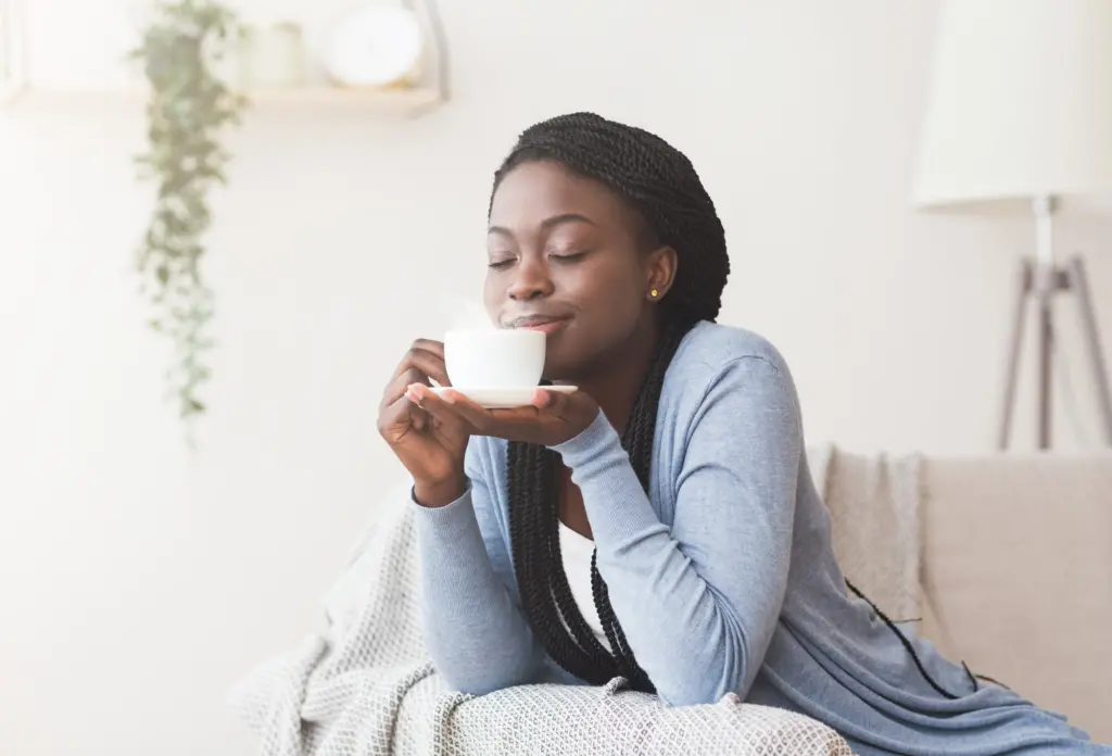 Woman enjoying a morning cup of coffee - how to practice gratitude